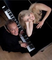 Ekaterina Kitáeva auf Flügel liegend, Walter Renneisen am Flügel spielend